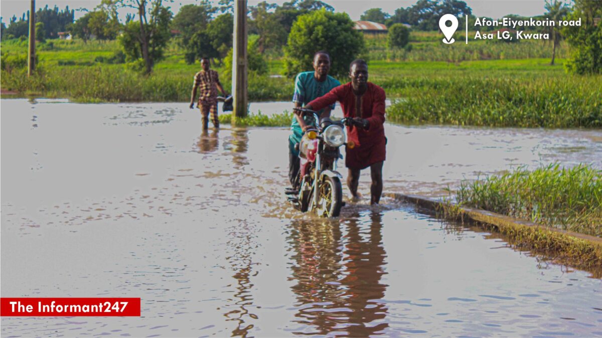 Okada riders were seen struggling to carry their bikes across the waterlogged road to proceed with their journeys