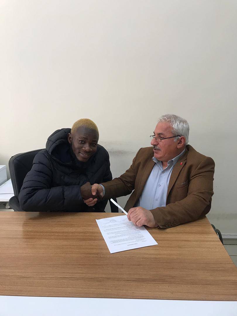 Grema Mohammed signing the dotted lines. 